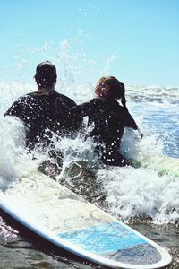 Man splashing water in sea