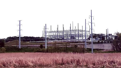 Metallic structure on field against clear sky