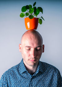 Portrait of young man against gray background