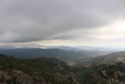 Scenic view of mountains against cloudy sky