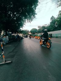 Cars on road in city against sky