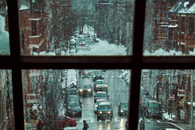 Cars on road seen through glass window