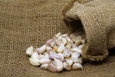 Close-up of garlics on jute