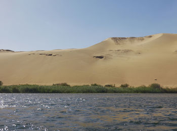 Scenic view of desert against clear blue sky