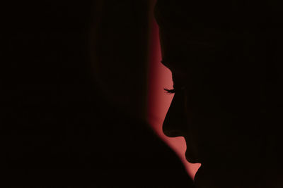 Close-up of  a woman' silhouette against red background