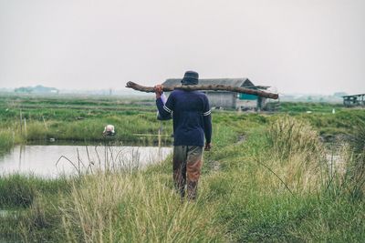 Rear view of man standing on field