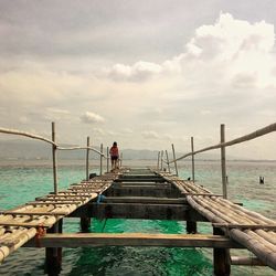 Pier on sea against sky