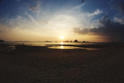 Scenic view of beach against sky during sunset