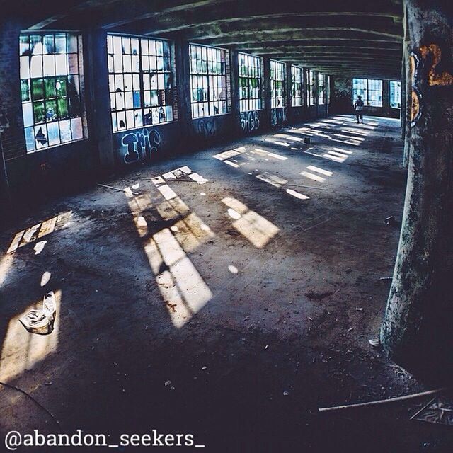 indoors, architecture, built structure, abandoned, window, empty, obsolete, sunlight, flooring, no people, graffiti, old, damaged, interior, absence, day, door, building, wall - building feature, shadow