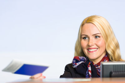 Friendly hostess with passport in airport