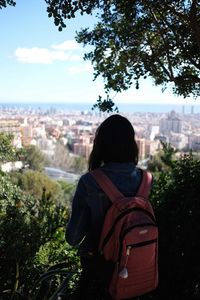 Rear view of woman looking at cityscape