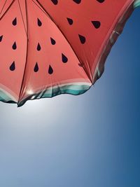 Low angle view of parasol against clear sky