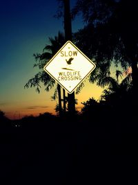 Road sign against sky