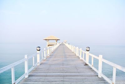 Pier over sea against clear sky