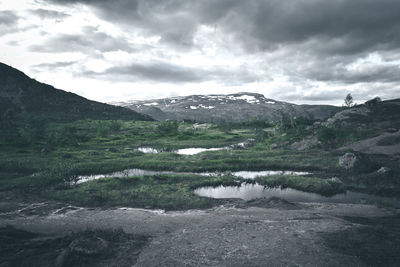 Scenic view of lake and mountains against sky