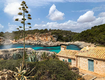 Scenic view of sea and buildings against sky