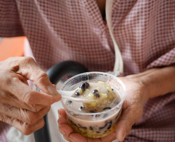 Midsection of man eating food