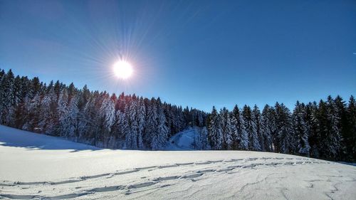 Scenic view of snow covered landscape against clear sky