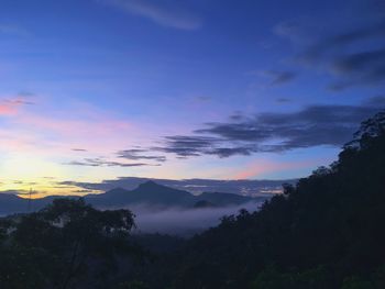 Scenic view of silhouette mountains against sky at sunset