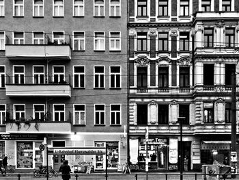 People on street against building in city