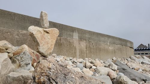 Low angle view of stone wall against sky