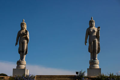 Low angle view of statue against blue sky