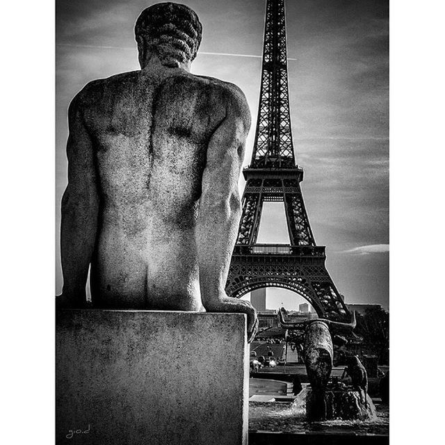 transfer print, auto post production filter, sky, sculpture, men, low angle view, built structure, statue, art and craft, creativity, architecture, human representation, art, eiffel tower, lifestyles, metal, leisure activity, international landmark