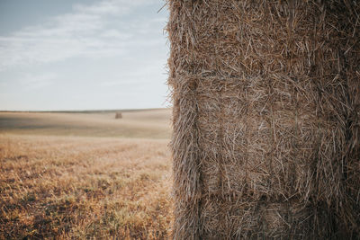 Hay bale on field against sky