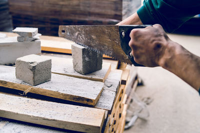 Cropped hand of man working on wood