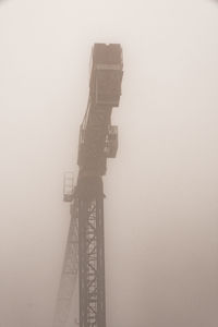 Low angle view of communications tower against sky
