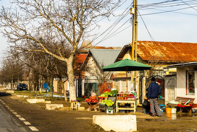 People in market against buildings in city