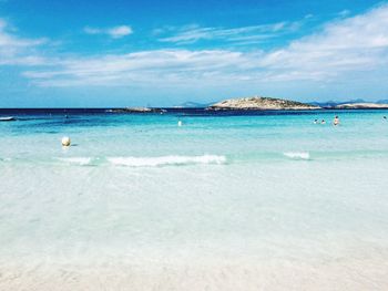 Scenic view of beach against blue sky