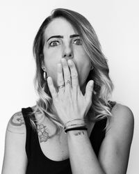 Portrait of young woman against white background
