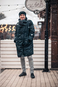 Full length of young man standing in snow