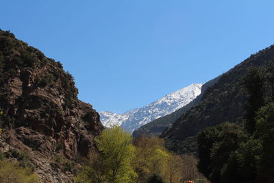 Scenic view of mountains against clear blue sky