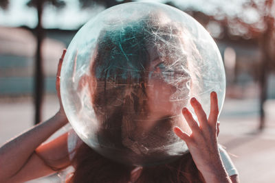 Close-up portrait of hand holding ball