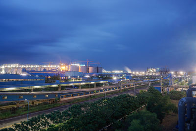 Illuminated city against sky at night