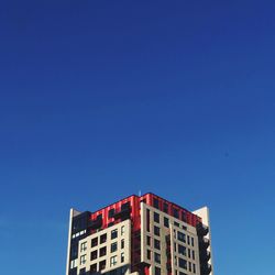 Low angle view of buildings against blue sky