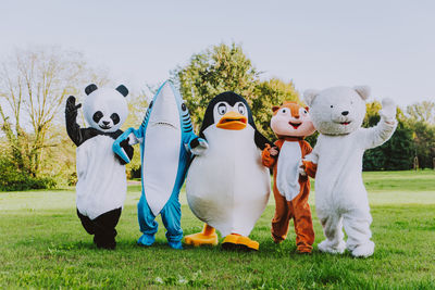 People wearing costume standing at park outdoors