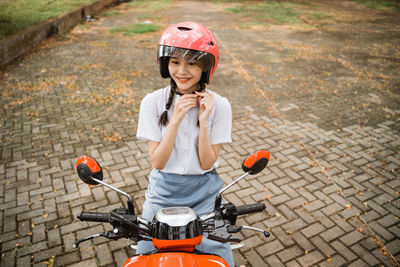 Portrait of boy playing with toy on road