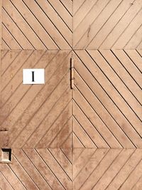 Letter i on closed wooden door