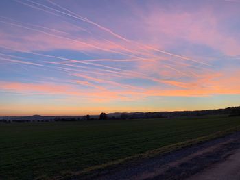 Scenic view of field against sky during sunset