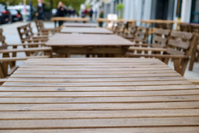 Empty tables and chairs at sidewalk cafe