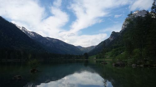 Scenic view of lake and mountains against sky