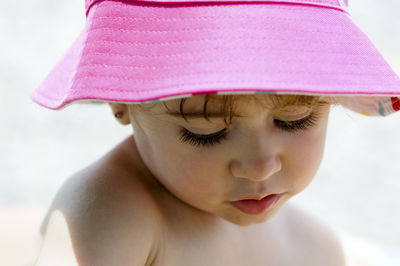 Close-up of cute girl wearing pink hat