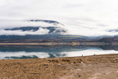 Reflection of the clouds and mountains on lake in san antoni reservoir in lleida, catalonia, spain