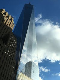 Low angle view of skyscrapers against blue sky