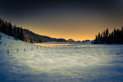 Scenic view of snow covered mountains against sky during sunset