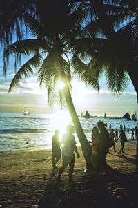 People at beach against sky