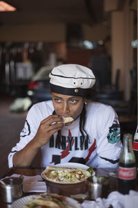 Young man eating at a restaurant